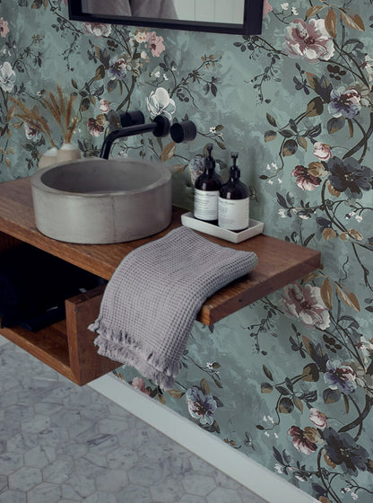 Moody floral wallpaper with pink, white, and plum flowers on a painterly teal background, perfect for romantic Cottagecore bedrooms or reading nooks